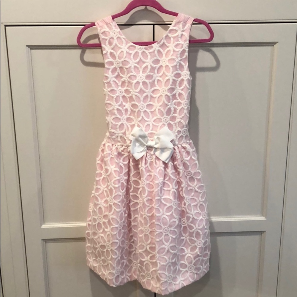 Pink gingham dress with floral overlay.
